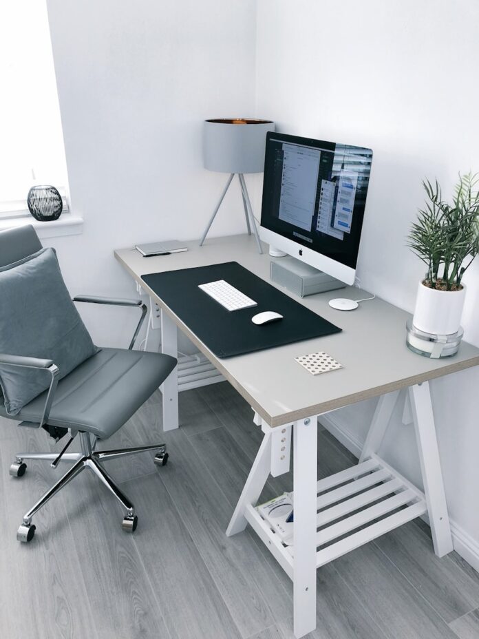 Photo by James McDonald gray leather office rolling armchair beside white wooden computer desk