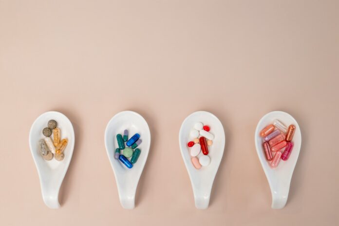 Photo by laura adai A row of spoons filled with different types of pills