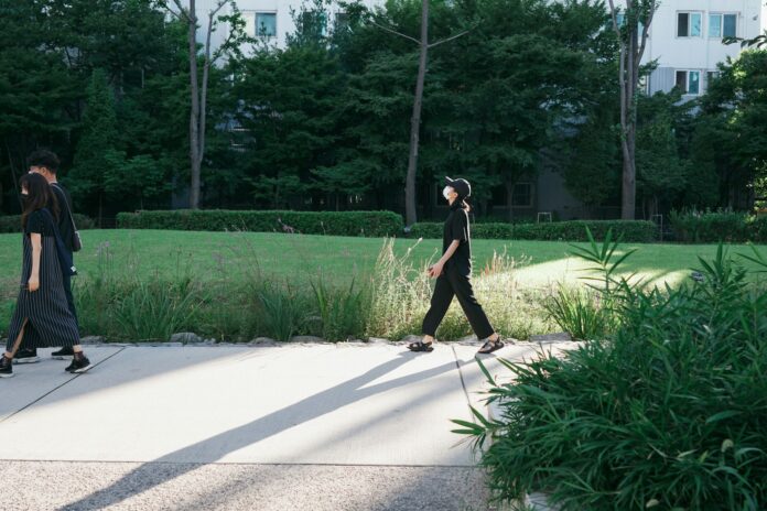 a man and woman walking down a sidewalk