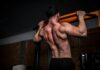 근육 건강, 일상 속 작은 변화로 지키는 법 topless man in black shorts holding orange bar