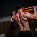 근육 건강, 일상 속 작은 변화로 지키는 법 topless man in black shorts holding orange bar