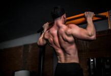 근육 건강, 일상 속 작은 변화로 지키는 법 topless man in black shorts holding orange bar